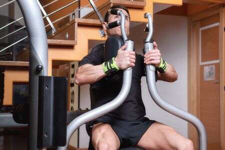 Handsome muscular man working out hard at gym. Training Chest exercises. Chest workouts.の写真素材