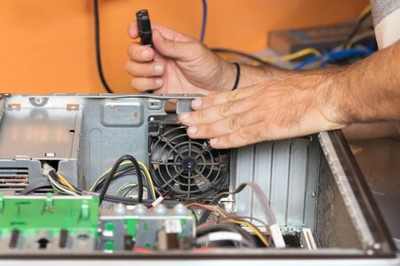 Technician repairing the computer. Concept of computer hardware, repairing, upgrade and technology.
