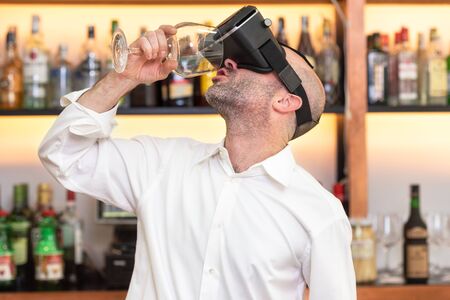 Barman apprentice training serving cocktail with virtual reality teacher. Apprentice learning how to...