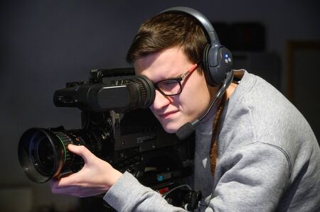 Cameraman using professional digital video camera.の写真素材