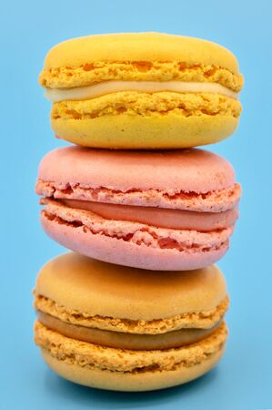Stack of sweet french macaroons with vintage pastel colored tone on blue background .の写真素材