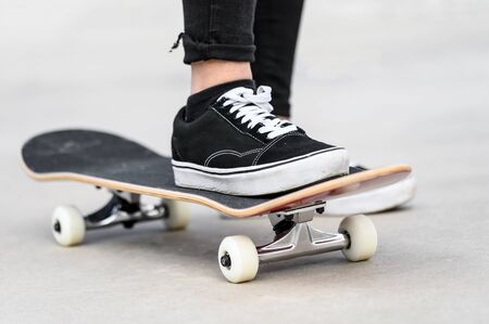Close up of young man riding a skateboard at the skate park .の写真素材