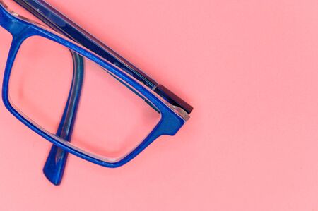 Close up of Blue glasses on pink background, top view .の写真素材