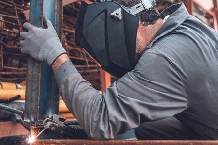 Welding work, Man Welding in Workshop. Metalwork and Sparks. Construction and Industrial concept.