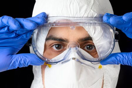 Covid-19 protective equipment. Portrait of Doctor or male nurse Wearing Personal Protective Equiment...