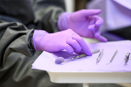 Gloved hand picking dental toolsの写真素材