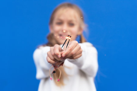 Little girl playing with Bengal lightsの写真素材