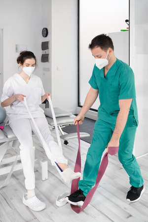 Team of physiotherapists practicing exercises for helping patientsの写真素材