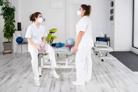 Team of physiotherapists practicing exercises for helping patientsの写真素材