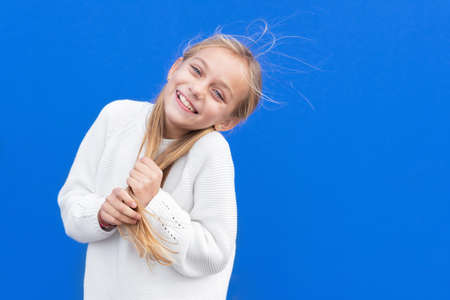 Overjoyed girl holding pigtails and laughingの写真素材