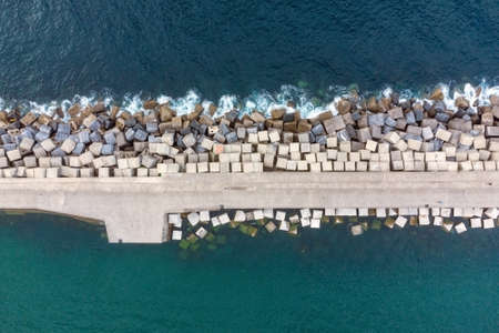 Aerial Drone Flying, Breakwater Of Stone In The Sea.