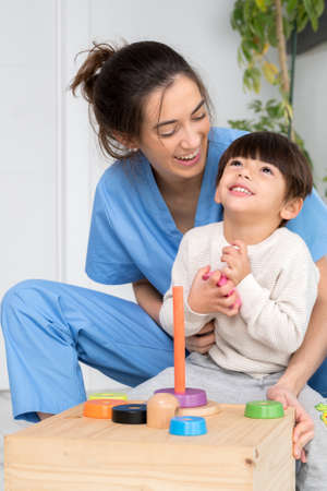 Disabled child is playing, learning and exercising in rehabilitation therapy hospital, Lifestyle of a child with disability. Happy disability kid concept.の写真素材