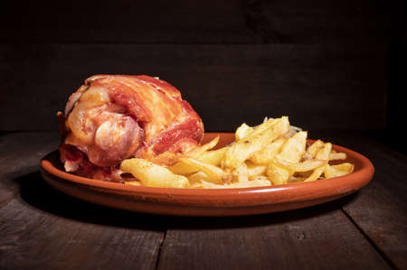 Pork Knuckle with Sauerkraut and fried Potatoesの写真素材