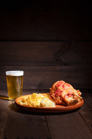 Traditional German cuisine roasted ham hock, sauerkraut and Beer, Oktoberfest background.の写真素材