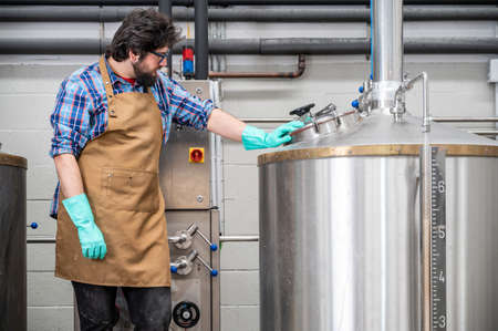 Man working on modern brewery.
