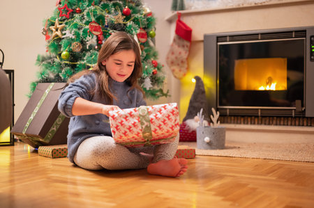 Cute girl opening christmas presentの写真素材