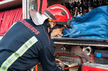 Firefighter check and maintenance equipment for working in area of fireplace office near fire truck.の写真素材