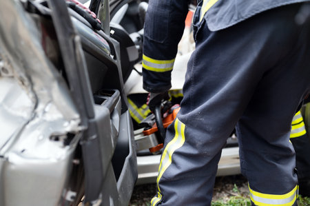 Car Crash Traffic Accident. Firefighters Rescue Injured Trapped Victims. Firemen give First Aid to passengers.の写真素材