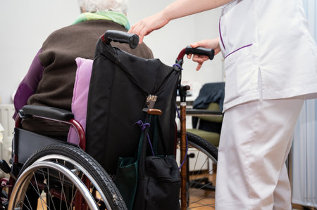 Young woman doctor give support to old lady patient with disability sitting in wheelchair, female caregiver or nurse take care of senior disabled grandma, elderly healthcare conceptの写真素材