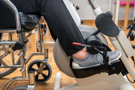 An unrecognizable elderly woman does pedal exercises from wheel chair at hospital.の写真素材