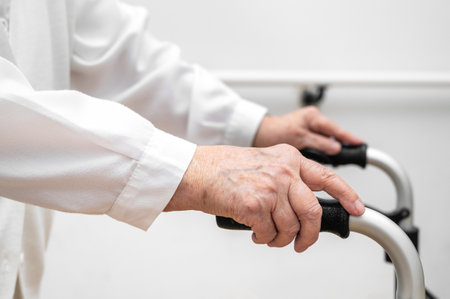 Senior patient on folding walker. Recuperation for elderly, seniors care, nursing home.の写真素材