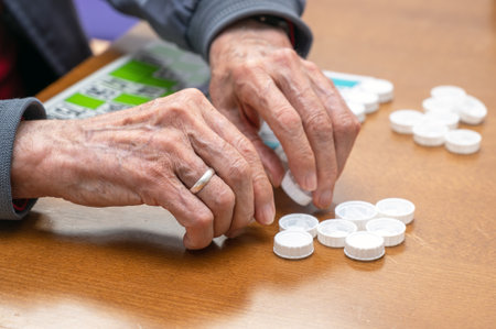 Close up of a senior man playing bingo at Nursing home. leisure game, support, assisted living, and retirement.の写真素材