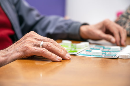 Close up of a senior man playing bingo at Nursing home. leisure game, support, assisted living, and retirement.の写真素材