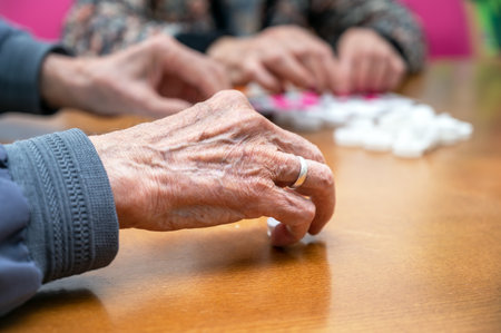 Close up of a senior group playing bingo at Nursing home. leisure game, support, assisted living, and retirement.の写真素材