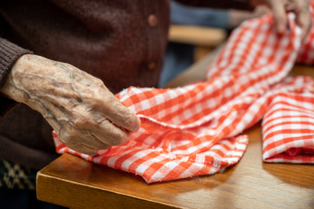 Elder hands, folding napkinsの写真素材