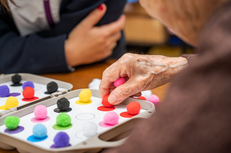 Rehabilitation center. Brain therapy cognitive psychological testing on senior patient. Alzheimers disease and dementia prevention concept. Adaptation skills recoveryの写真素材