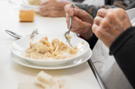 Close up of an elderly man having lunch at nursing home.の写真素材