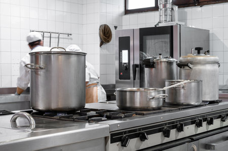 Chefs cooking food in commercial kitchenの写真素材