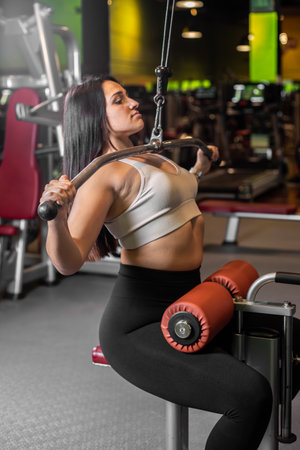 Fitness woman doing back exercises in gym.