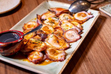 Pplate of Grilled octopus with olive oil.