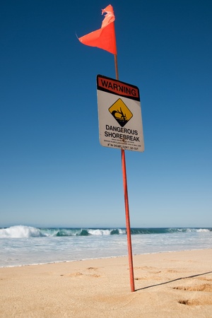 Danger flag with no swimming sign on beachの写真素材