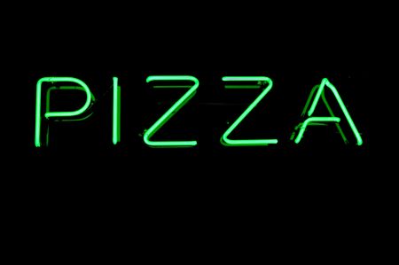 Green Neon Pizza Sign on Black, Copy Spaceの写真素材