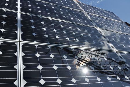 Solar Panel with Reflection of Wind Turbine and Sun