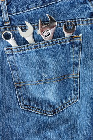 Close-up of Four Wrenches in Blue Jean Pocketの写真素材