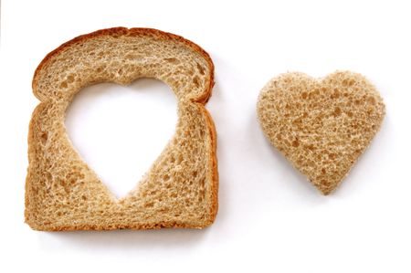 Wheat Bread Slice with Heart Isolated on Whiteの写真素材