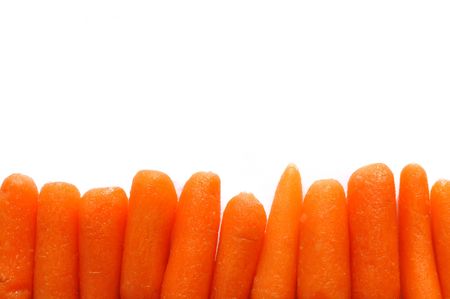 A Row of Baby Carrots Forming a Bottom Borderの写真素材
