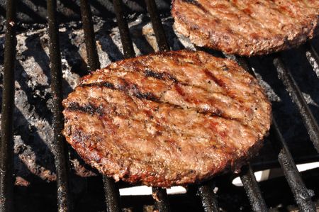 Hamburgers cooking on the grill, copy spaceの写真素材