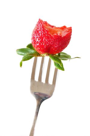 Strawberry on Fork with Bite Taken Isolated on Whiteの写真素材