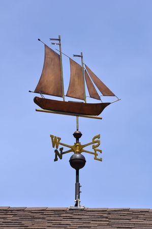 Sailboat (Schooner) Weather Vane on a Roofの写真素材