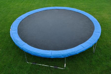 A Round Trampoline on the Back Yard Grassの写真素材