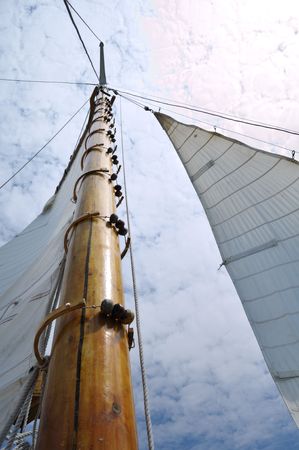 Jib and Wooden Mast of Schooner Sailboat on a Sunny Summer Dayの写真素材