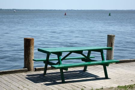 Green Wooden Picnic Table by a Lake