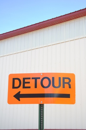 Orange Detour Sign with an Arrow Pointing Leftの写真素材
