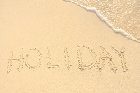 The Word Hoilday Written in the Sand on a Beachの写真素材