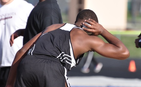 SPRING LAKE PARK, MN - May 3: Unidentified Teen Boy Perparing to Toss the Shot Put at a High School Track and Field Meet on May 3, 2011 in Spring Lake Park, Minnesota.のeditorial素材