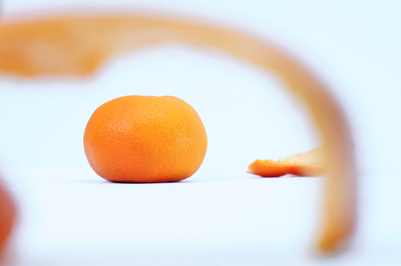 Fresh orange and orange peeles skin as foreground isolated on white backdropの写真素材